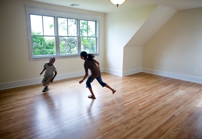 Kids running around empty room in new house