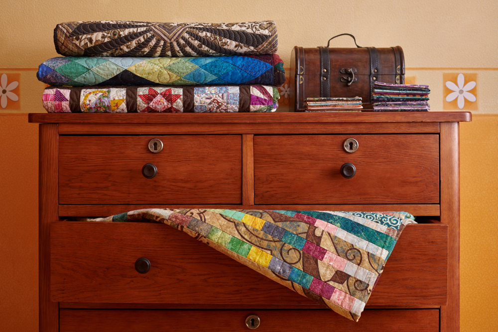 stack of quilts on a dresser