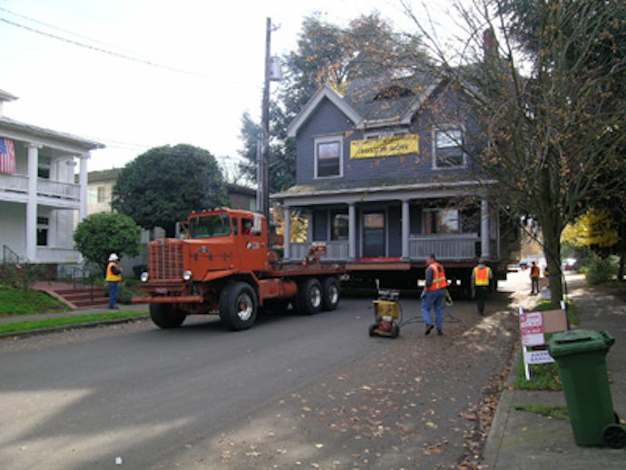 The Portland house is carefully transported to a new lot.