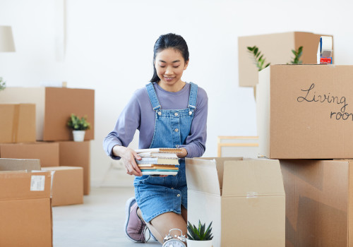 woman packing books in moving boxes