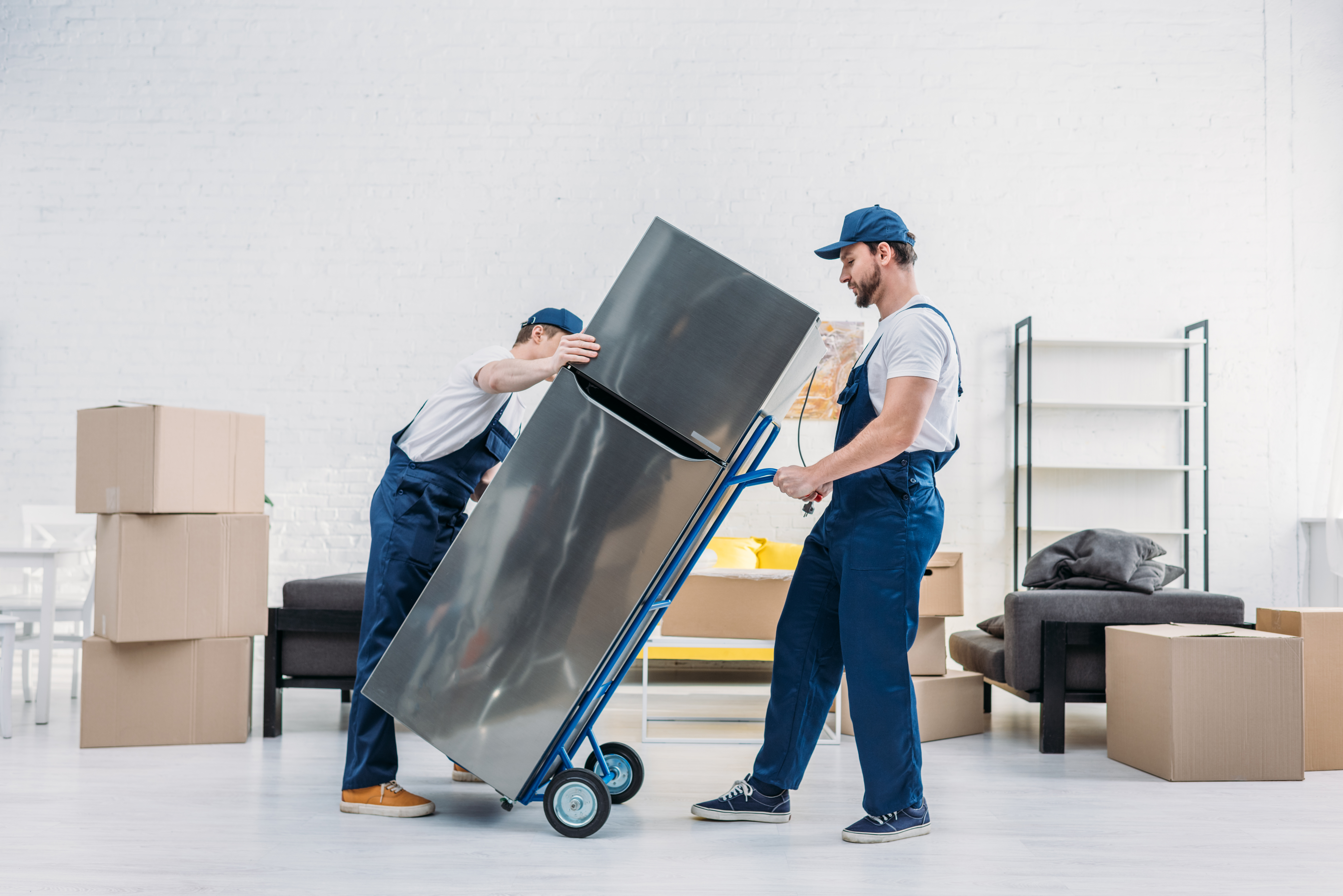 two movers moving a refrigerator