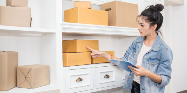 woman taking inventory of boxes