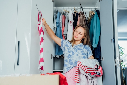 woman selecting clothes from her wardrobe
