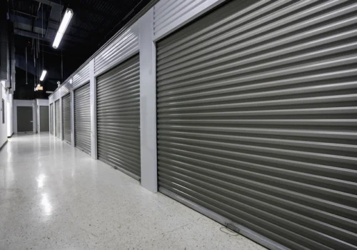 Image of indoor climate-controlled storage units, dark rollup doors, well lit hallways
