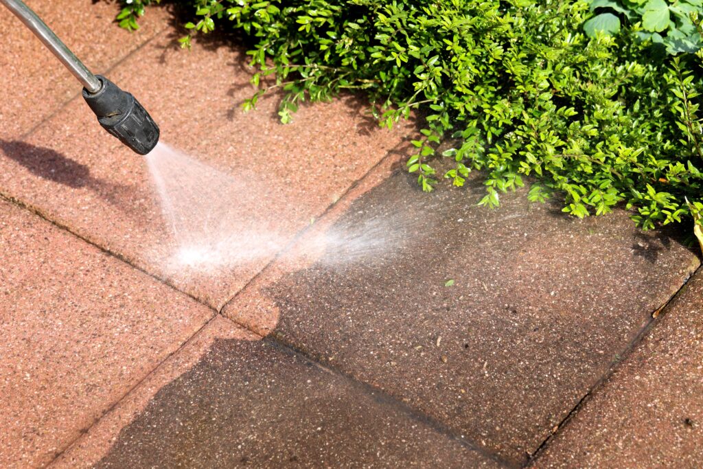 a stone walkway being power washed