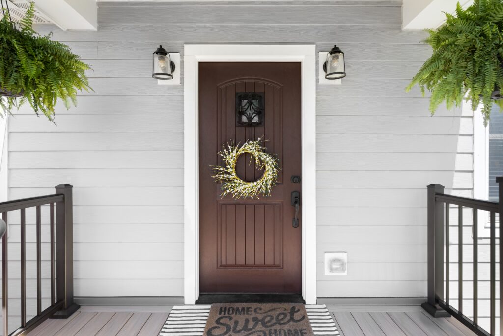 wooden door in front of a home with a simple wreath to increase curb appeal