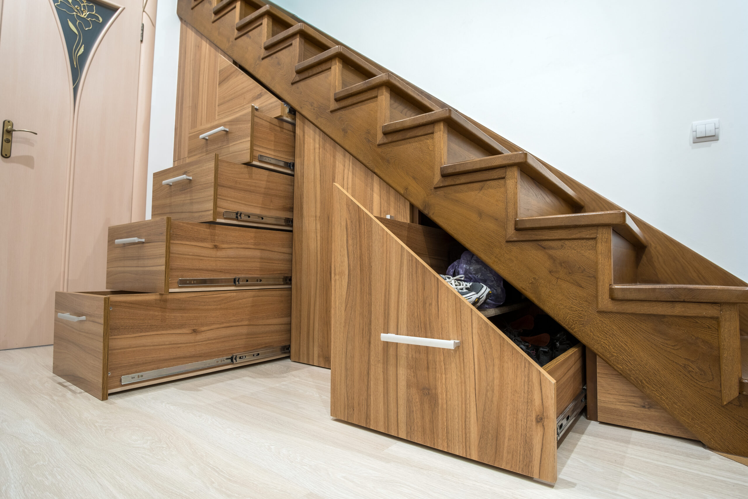 Image of custom-built drawers under the stairs as additional storage