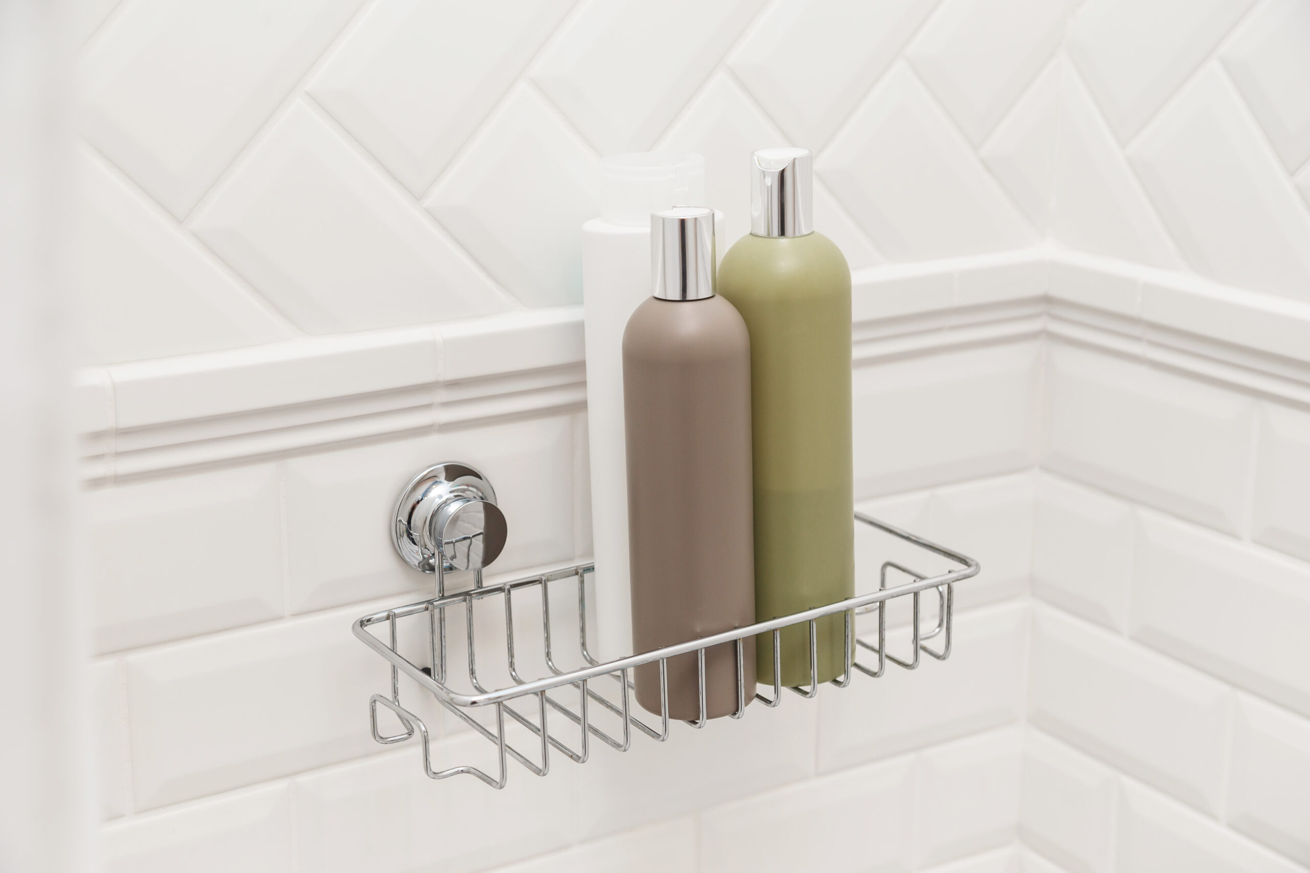 shower caddy with bottles of shampoo in a bathroom