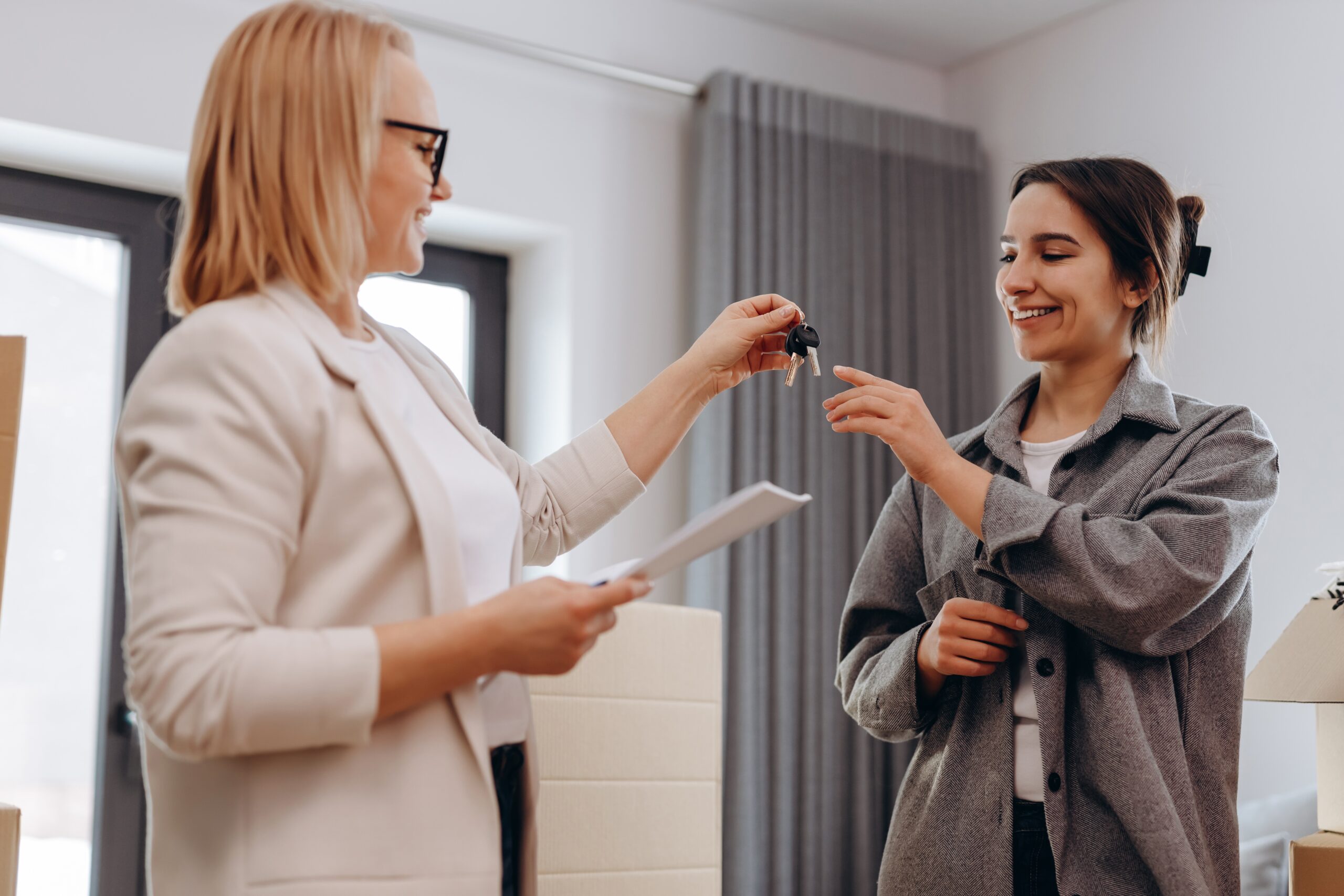 a tenant receiving house keys from her landlord