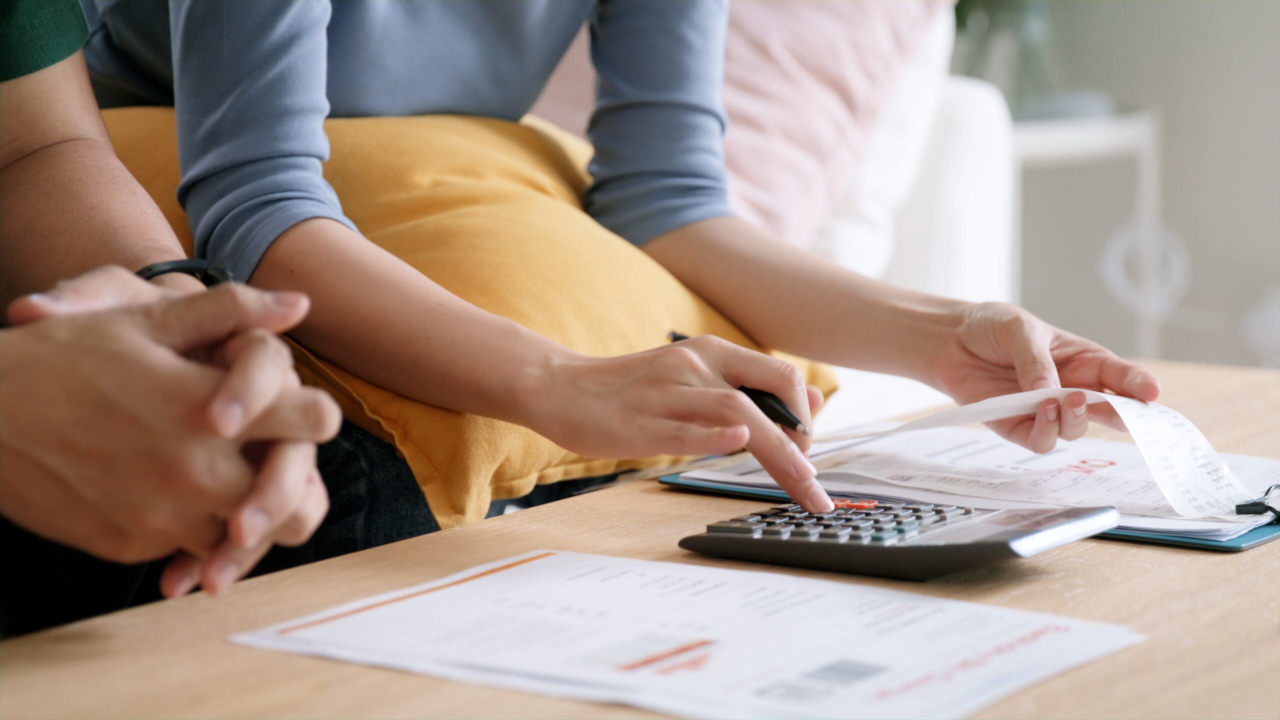A couple calculating cost of living and planning budget